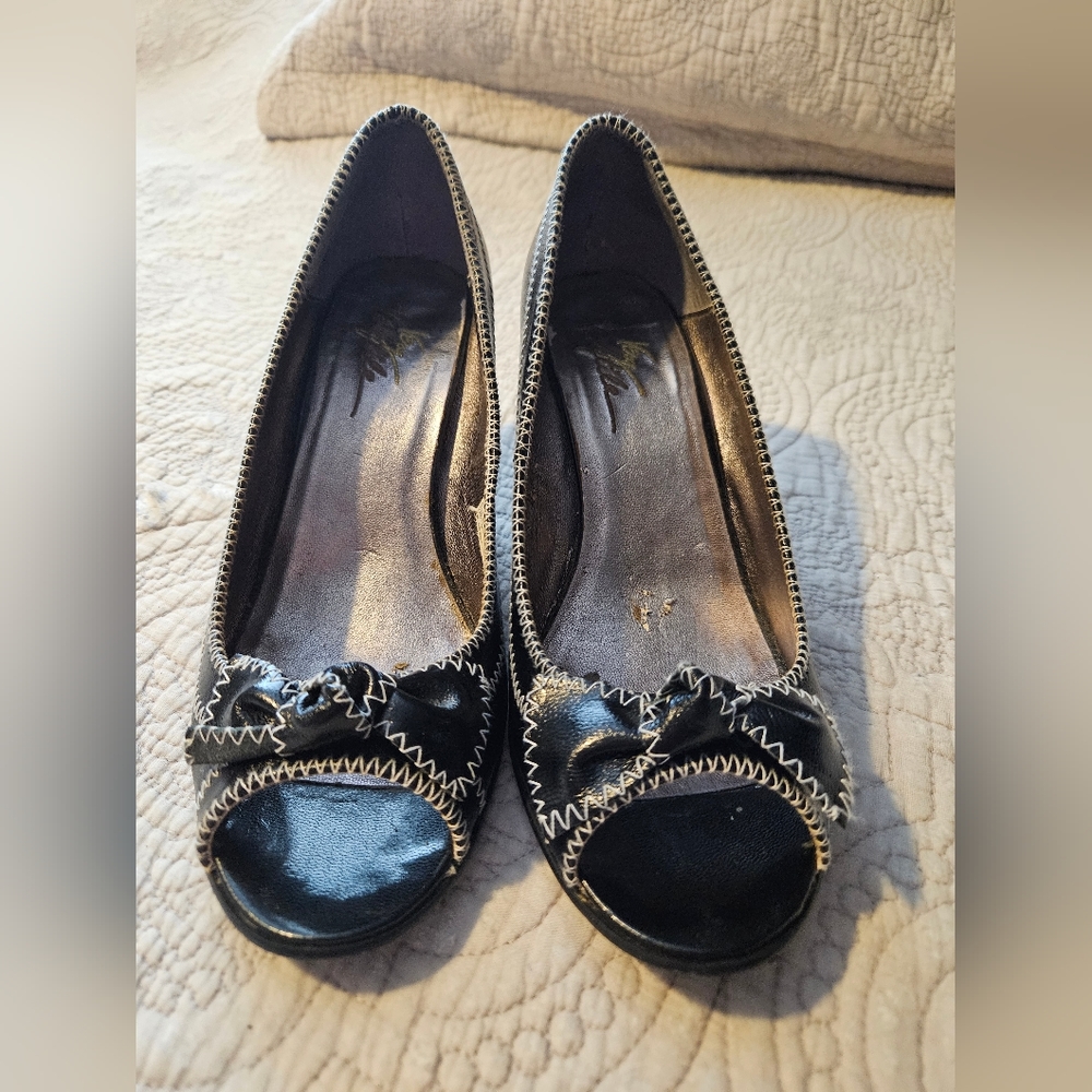 Black with white trimming around the shoes. 3in heels, bows on front of shoe